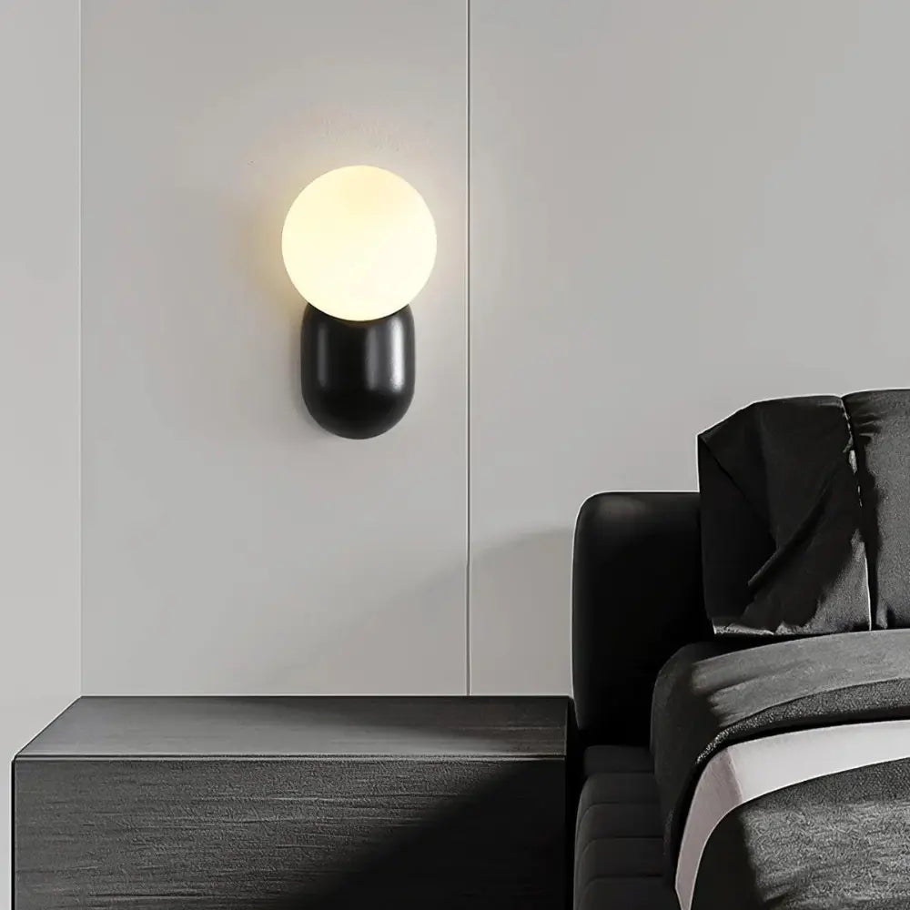 Modern Globe Wall Light Black Metal and Glass Orb - Product example