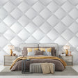 Modern white 3D diamond wallpaper in a bright living room with minimal furniture and large windows