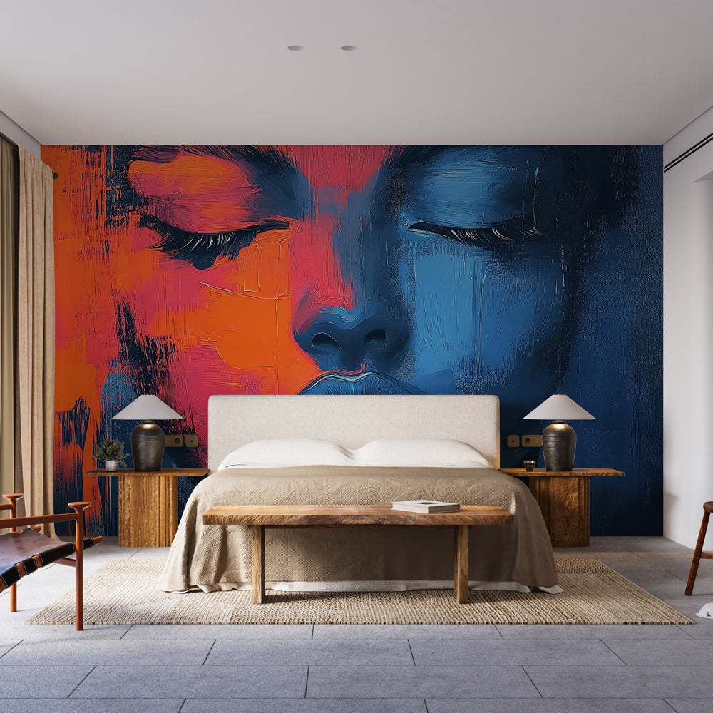 Modern abstract face mural wallpaper creating drama in a minimalist living room with blue and orange tones