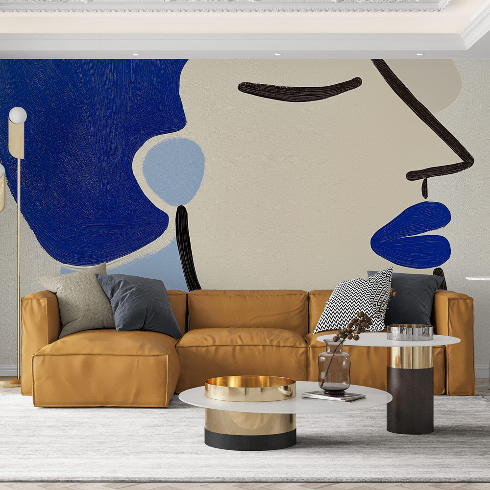 Modern abstract face wallpaper creating a dramatic focal point in a minimalist living room with blue accent furniture