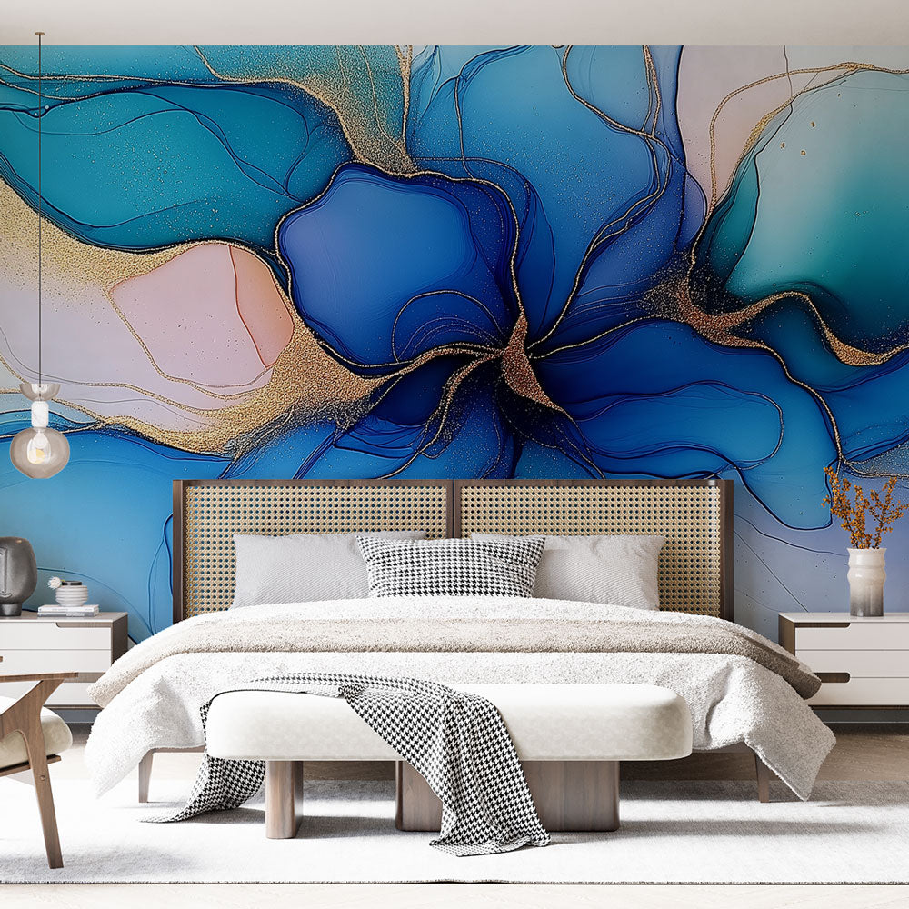 Blue and gold abstract floral wallpaper creating a luxury statement wall in a modern living room with clean furniture