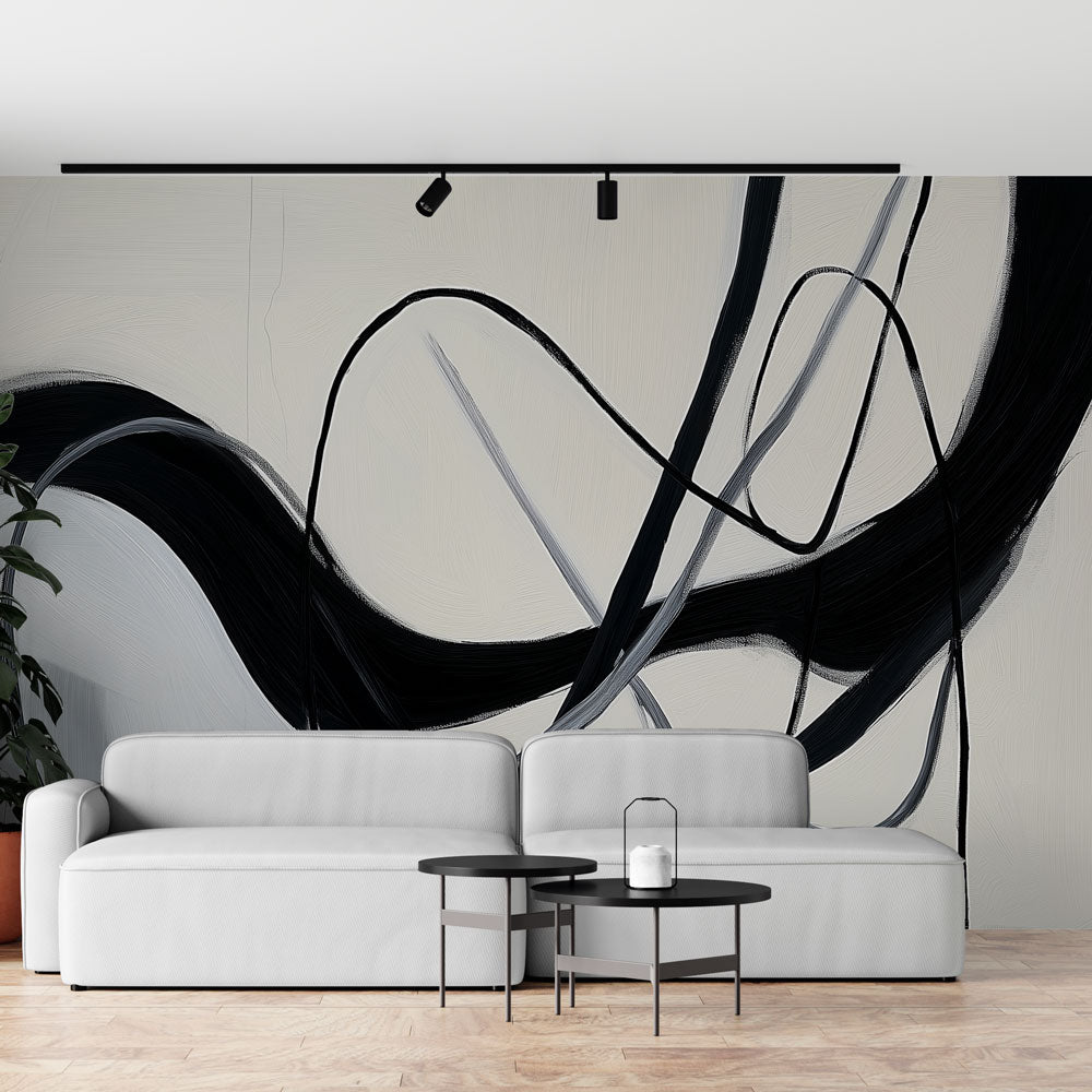 Black and white abstract wallpaper with organic lines creating dramatic impact in a modern living room setting