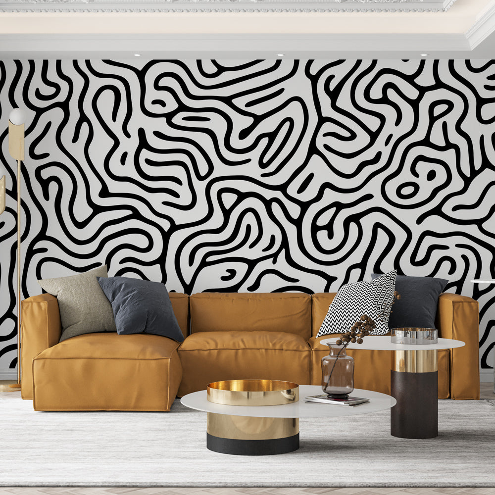 Black and white abstract pattern wallpaper creating dramatic impact in a modern minimalist living room setting