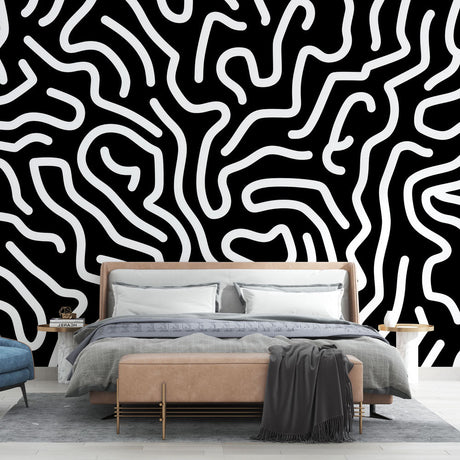 Abstract black and white wallpaper creating a striking modern look in a minimalist living room setting