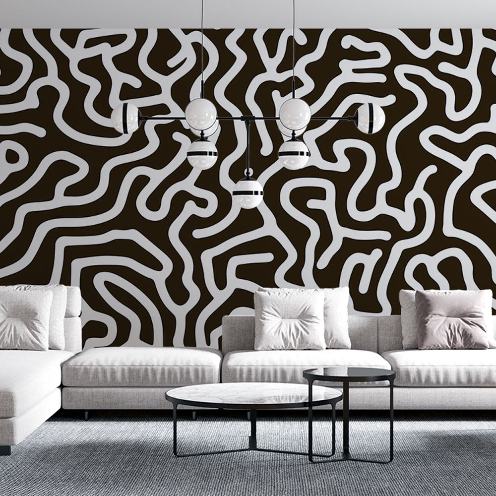 Black and white abstract wallpaper mural showcased in a modern living room with minimalist furniture