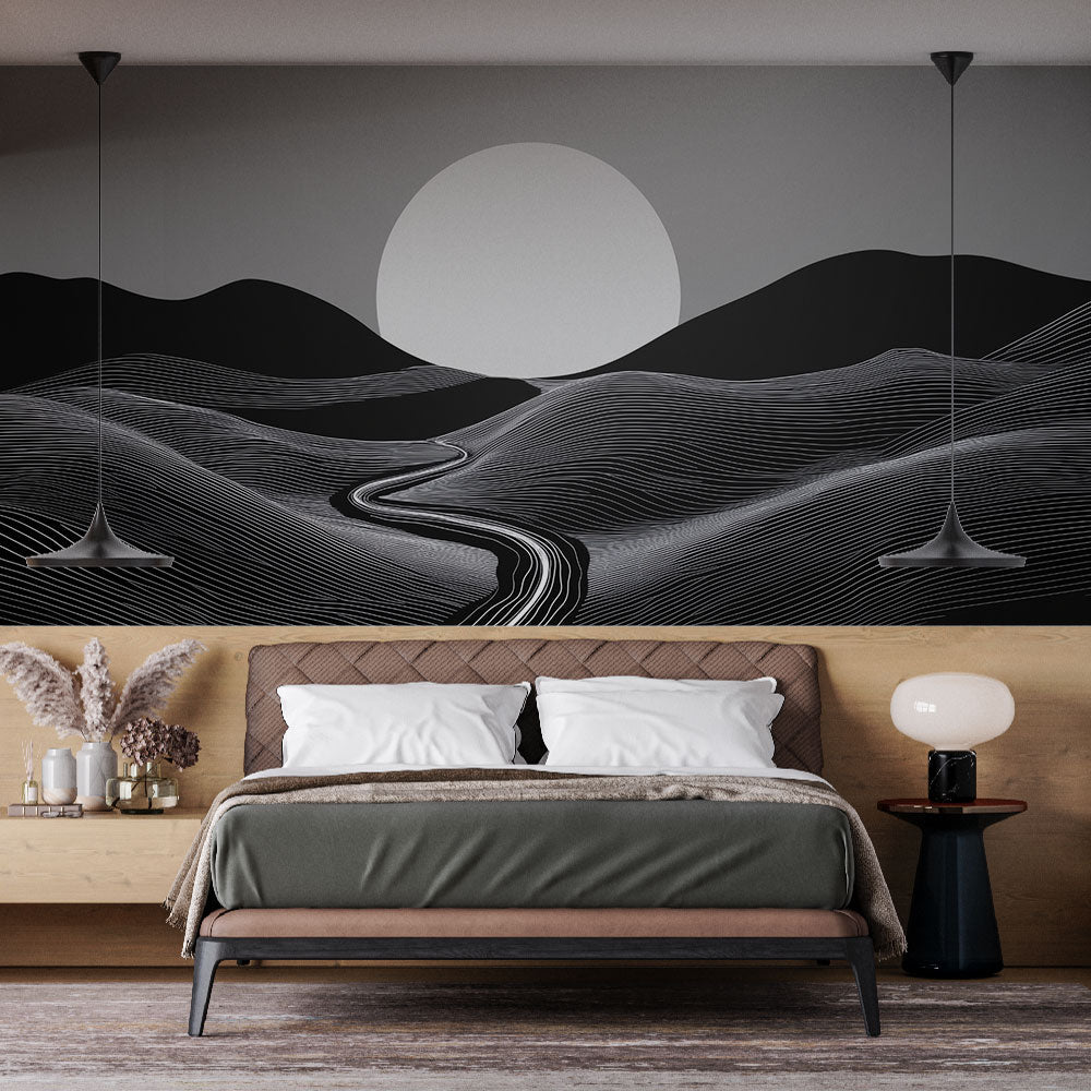Modern abstract black and white landscape mural displayed in a minimal living room setting with natural light
