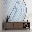 Modern blue wave wallpaper in a minimalist living room creating a serene atmosphere