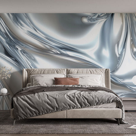Silver abstract wallpaper creating depth in a modern living room with natural light highlighting the metallic waves