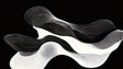 Abstract line art wallpaper in modern living room showing flowing black and white pattern creating depth