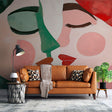 Modern abstract face wallpaper creating an artistic focal point in a minimalist living room with natural lighting