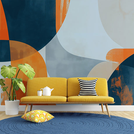 Modern geometric wallpaper with orange and navy shapes bringing life to a minimalist living room space