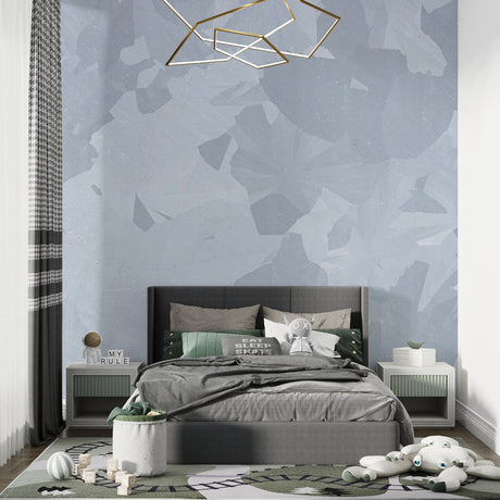 Modern grey geometric wallpaper in a minimal living room setting with natural light highlighting the pattern