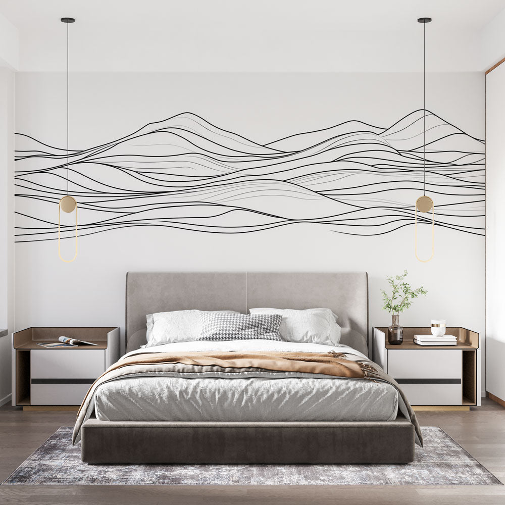 Modern line art mountain wallpaper in a bright minimalist living room showing flowing black lines against white walls