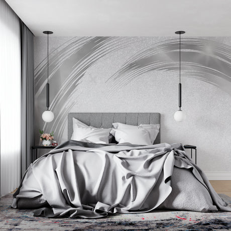 Modern silver brushstroke wall mural in a bright living room with grey sofa and natural light