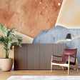 Abstract terracotta and blue wallpaper in a modern living room setting with minimalist furniture