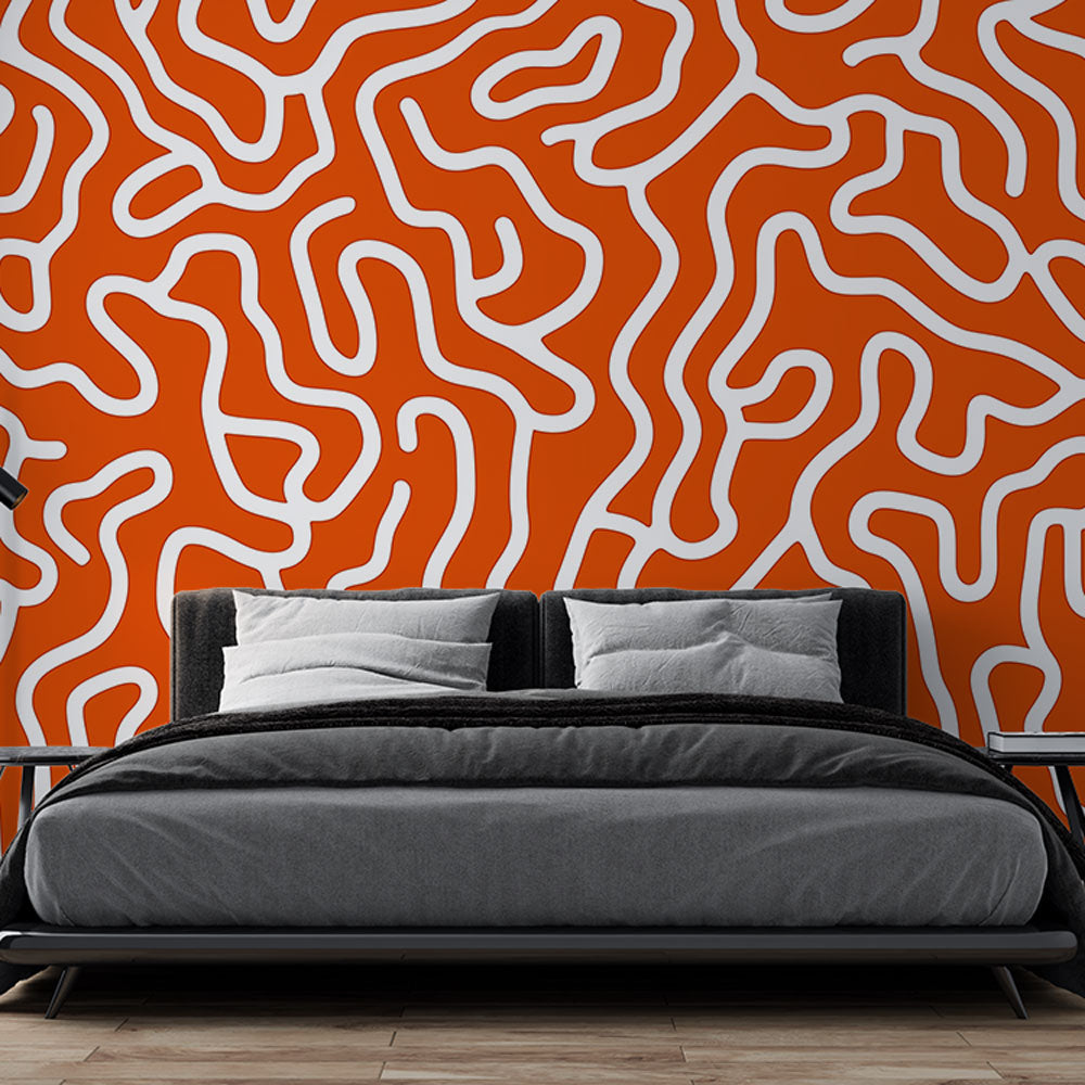 Modern orange geometric wallpaper creating a dynamic focal point in a bright contemporary living room setting