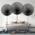 Modern abstract wall mural with black geometric circles displayed in a bright, contemporary living room setting