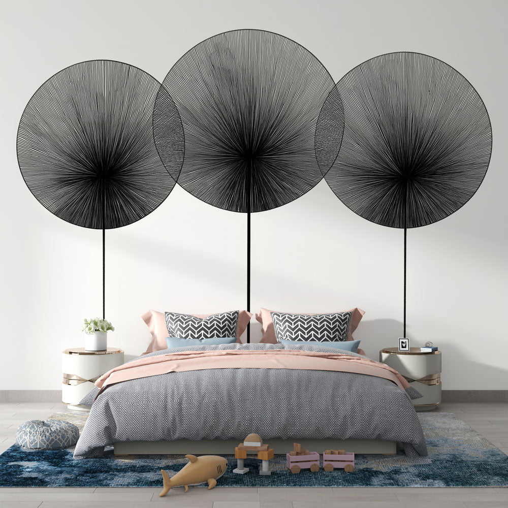 Modern abstract wall mural with black geometric circles displayed in a bright, contemporary living room setting