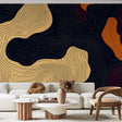 Abstract gold and black topographic wallpaper in a modern living room setting with minimal furniture and ambient lighting