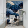 Art deco shell pattern wallpaper in modern living room with blue accent chairs