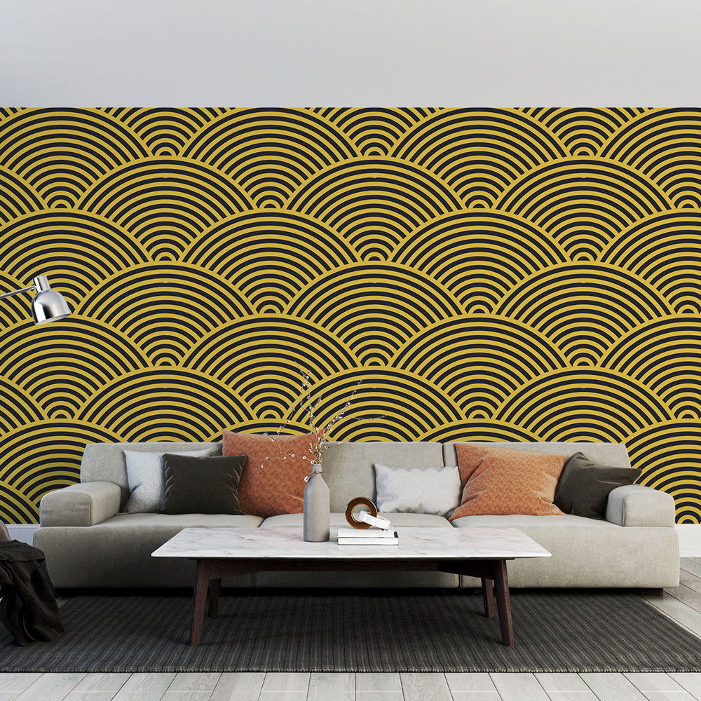 Art deco gold wave wallpaper mural styled in a modern dining room with pendant lights and dark furniture
