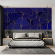 Navy and gold Art Deco wallpaper with ginkgo leaves pattern in modern living room creating elegant atmosphere