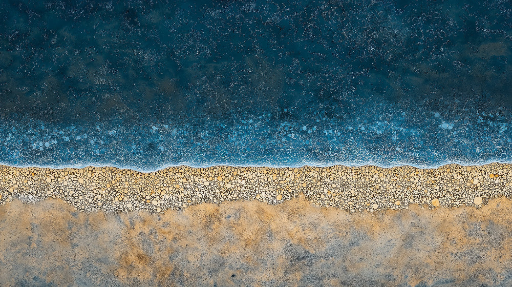 Abstract coastal design file showing detailed sand and sea pattern with rich blue ocean tones