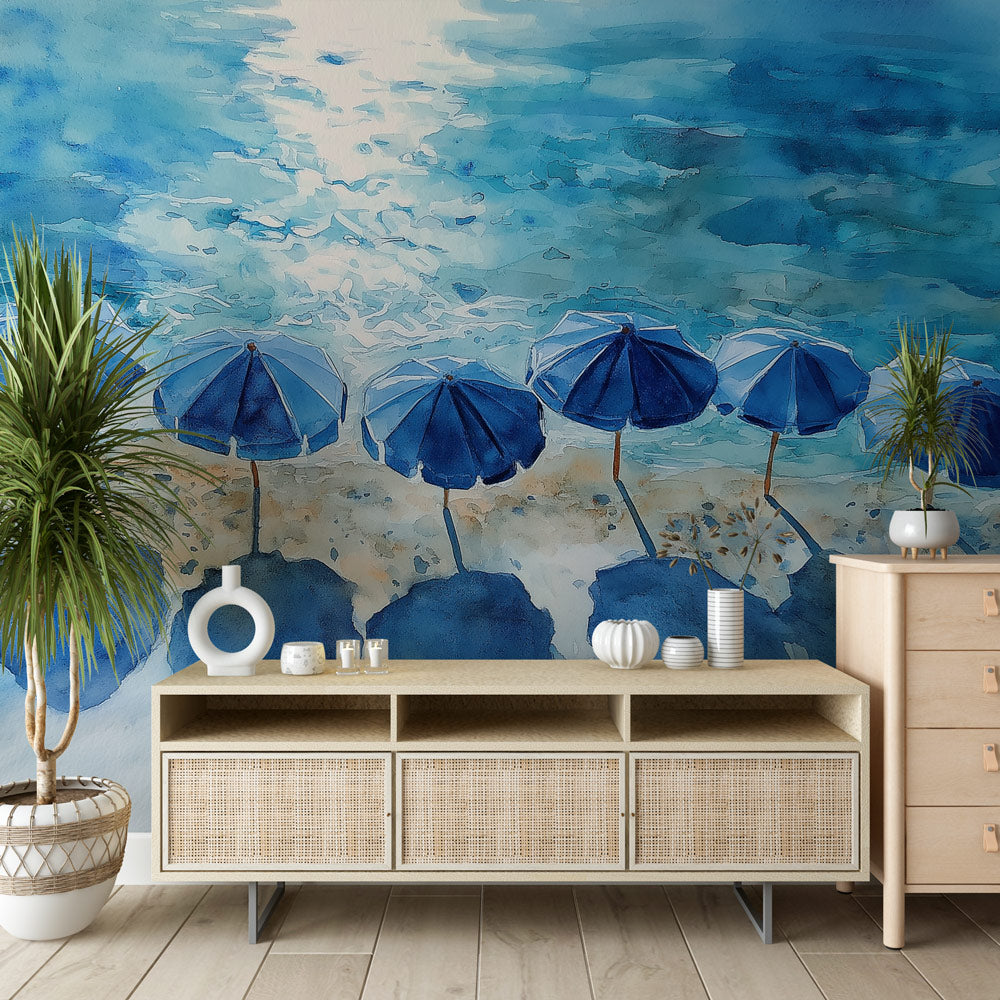Beach scene wallpaper with blue parasols creating a coastal atmosphere in a bright living room with white furniture