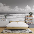 Black and white beach wallpaper creating a stunning focal point in a modern living room with minimalist furniture