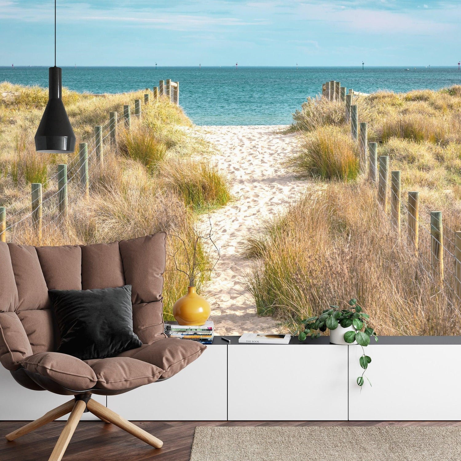 Coastal beach wallpaper adding depth to a minimalist dining room space