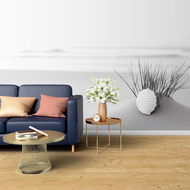 Black and white beach scene wallpaper creating a calm atmosphere in a modern living room with minimal furniture