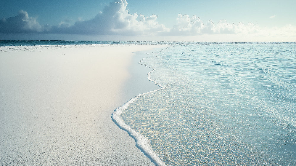 Beach wallpaper design file showing pristine ocean shore with white sand and gentle waves