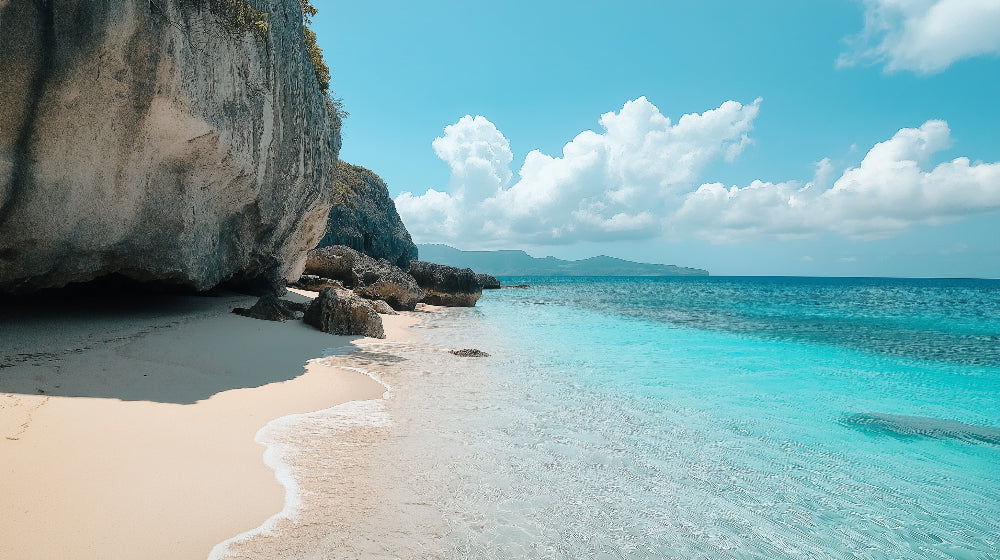 Beach wallpaper mural styled in bright modern living room, showing turquoise ocean and limestone cliffs creating depth