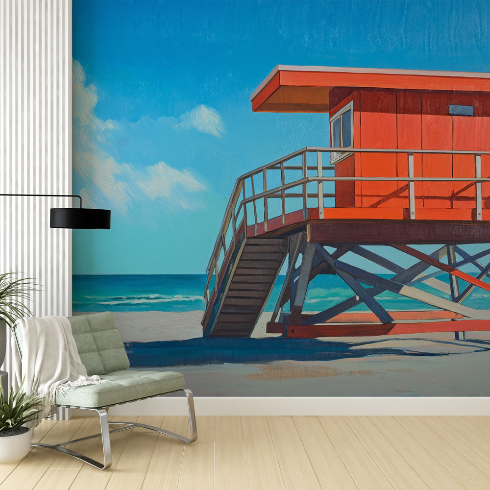 Beach scene wallpaper with orange lifeguard tower shown in bright modern living room with coastal decor