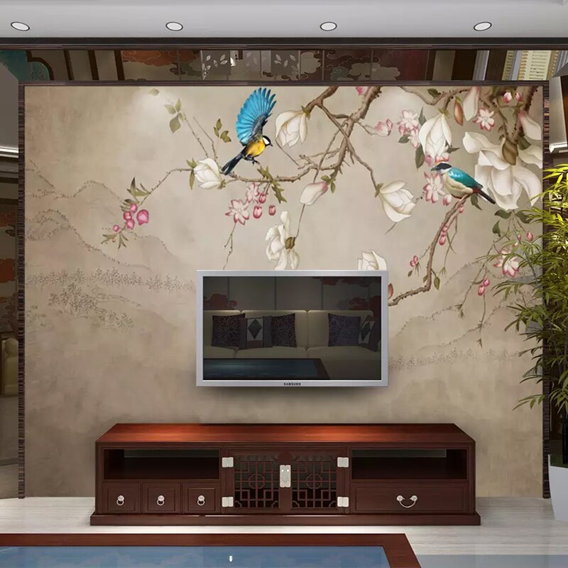 Bird and magnolia wallpaper creating an accent wall in a home office