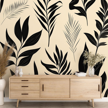 Black and beige tropical leaves wallpaper creating a modern accent wall in a bright minimalist living room setting