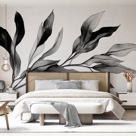 Black and white botanical wall mural creating a calm atmosphere in a modern living room with minimal furniture