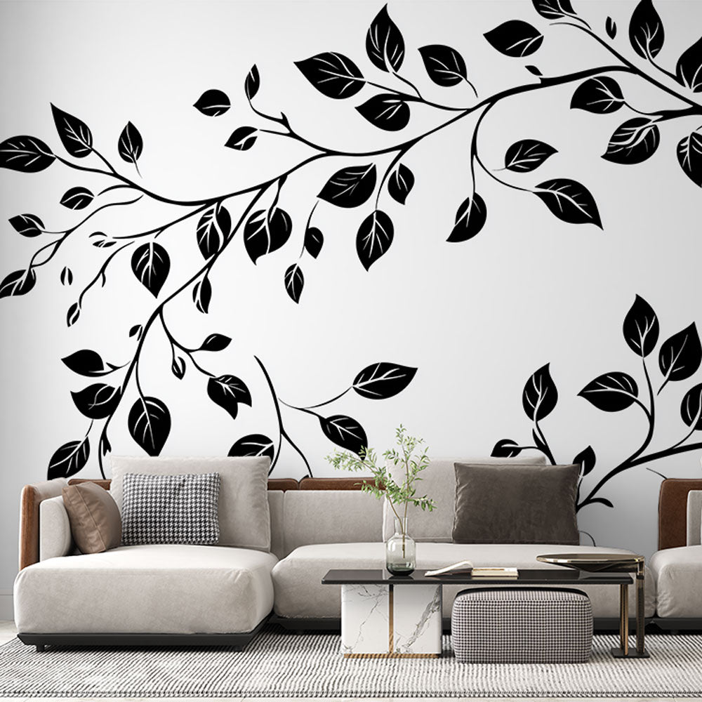 Black and white botanical wallpaper creating a striking feature wall in a modern living room with minimal furniture