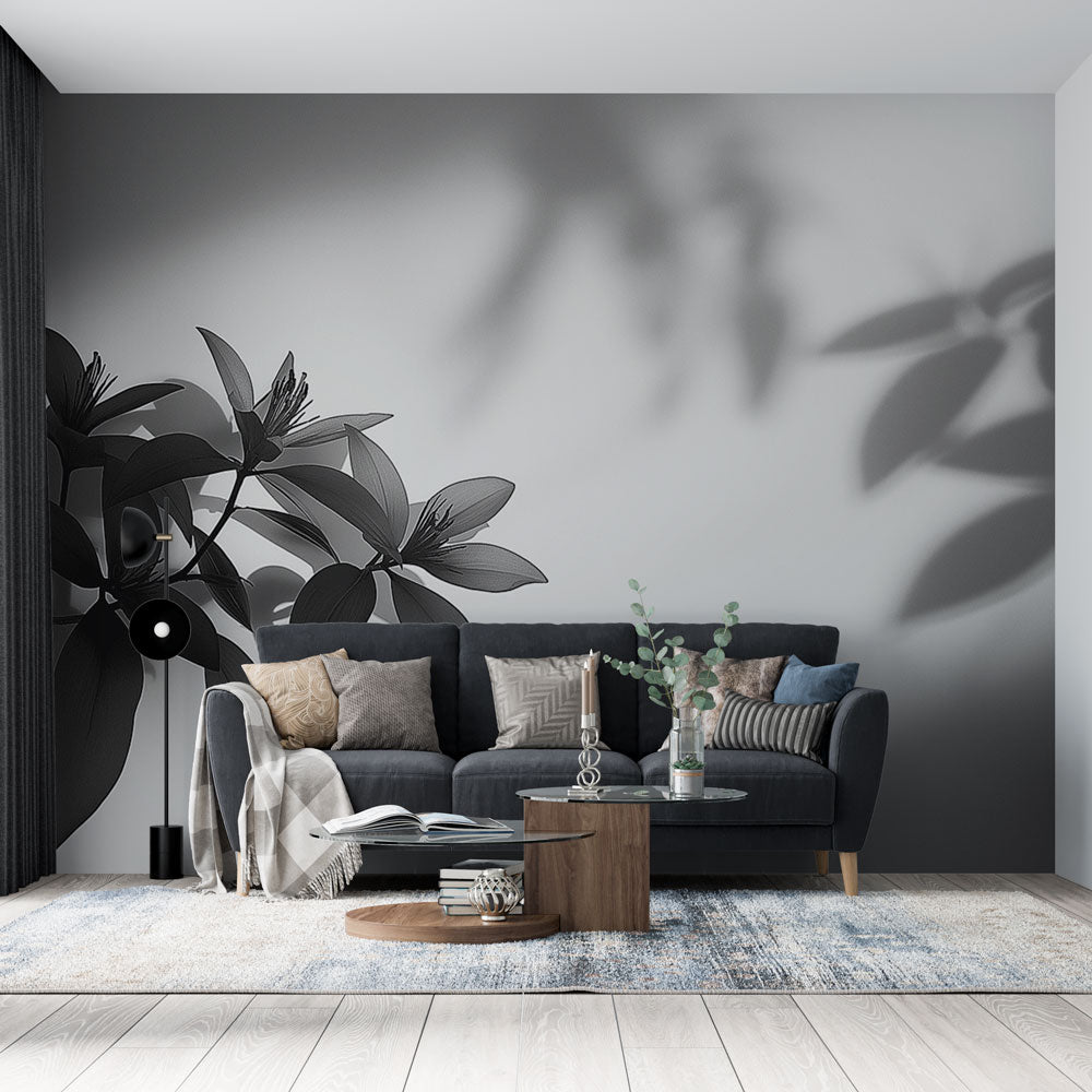 Black and white botanical wallpaper creating dramatic shadows in a modern living room with high ceilings