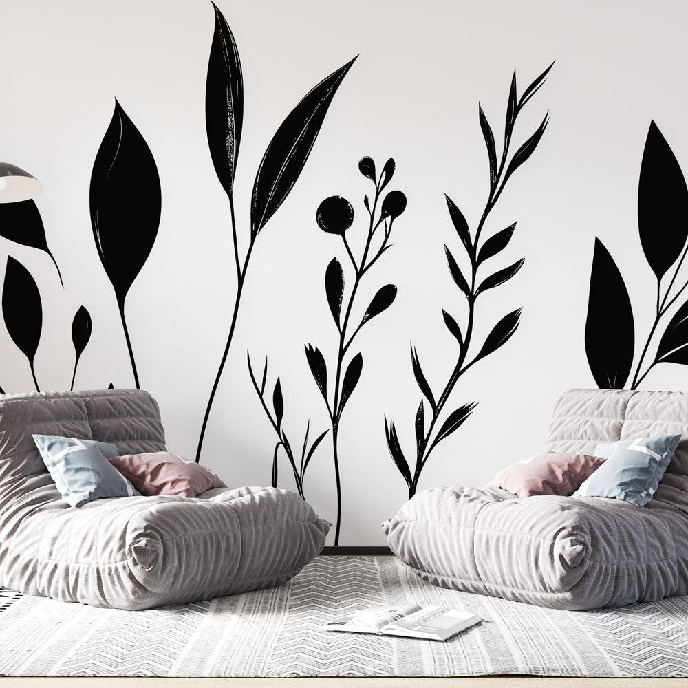 Black and white botanical wallpaper creating a calm atmosphere in a modern living room with minimal furniture