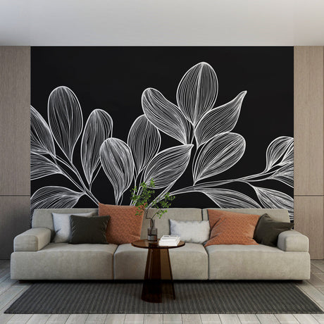 Black and white botanical line art wallpaper creating a striking focal point in a modern living room with natural lighting
