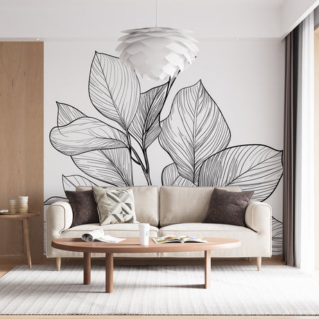 Black line art botanical wallpaper creating a modern statement wall in a bright, minimalist living room setting