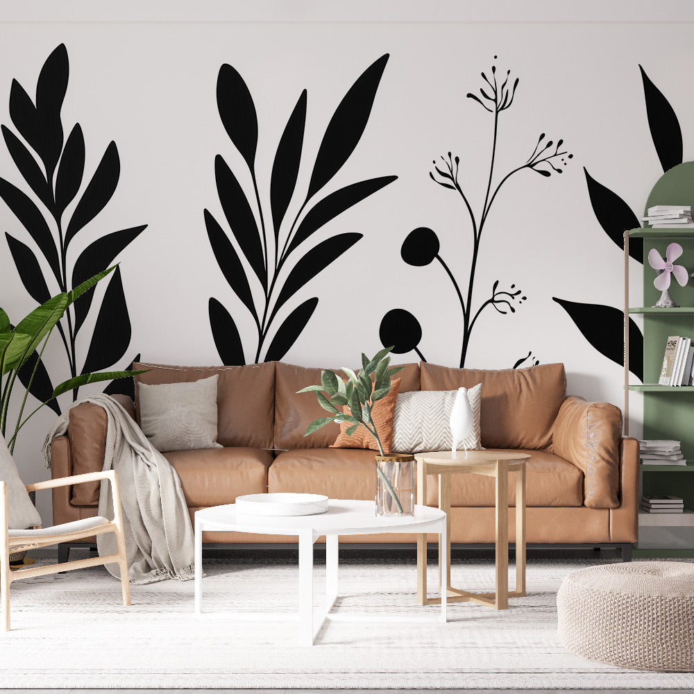 Black and white botanical wallpaper creating a modern statement wall in a bright living room with minimal furniture