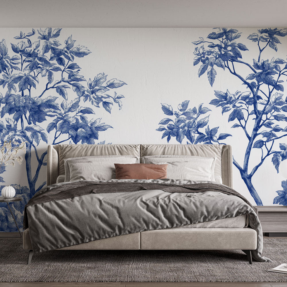 Botanical wall mural with blue leaves pattern creating a serene atmosphere in a modern living room