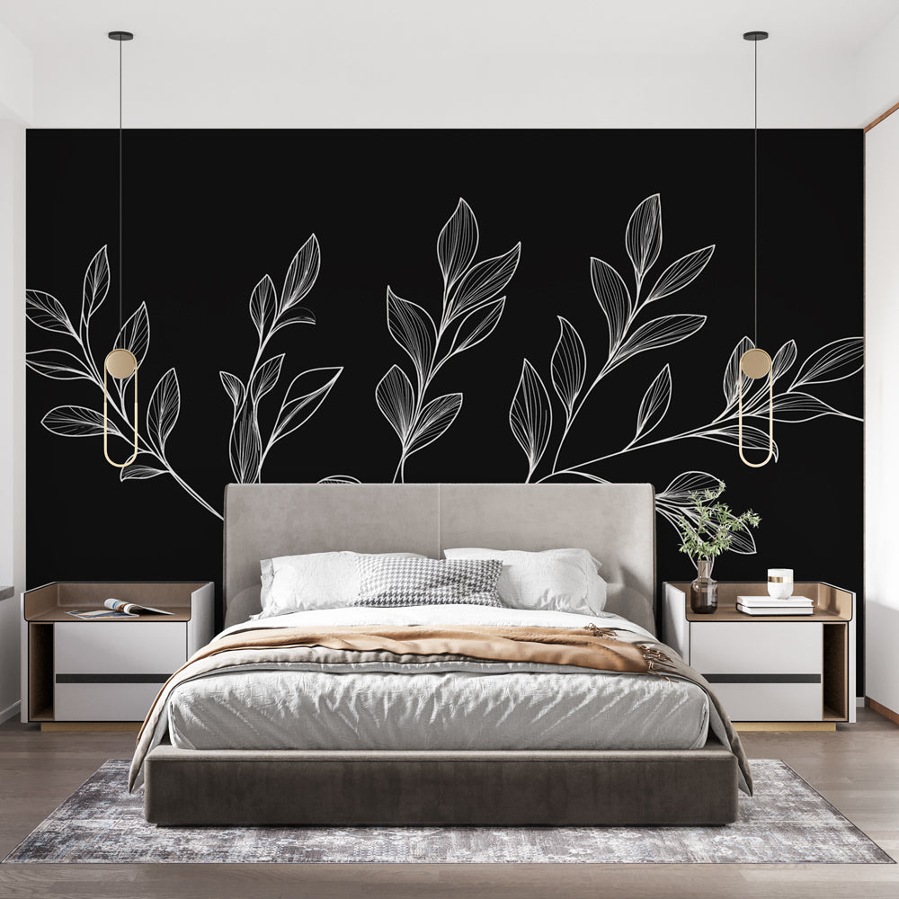 Black and white botanical wallpaper mural creating drama in a modern living room with minimalist furniture