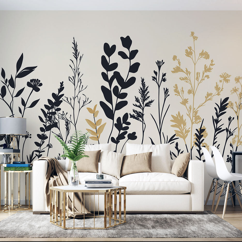 Black and gold botanical wallpaper creating an elegant statement wall in a modern minimalist living room with natural light