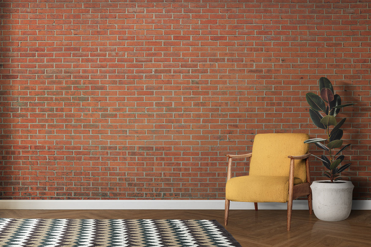 Red brick wall mural in modern living room showing industrial style with grey sofa and metal accents