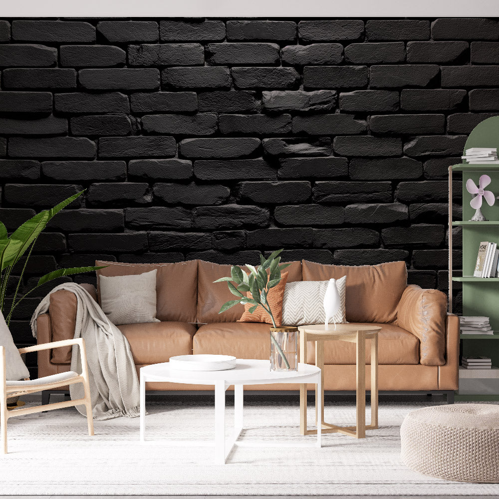 Black brick wallpaper creating modern industrial atmosphere in spacious living room with grey sofa and metal accents