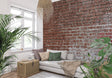 Red brick wallpaper mural in modern living room with gray sofa and industrial lighting