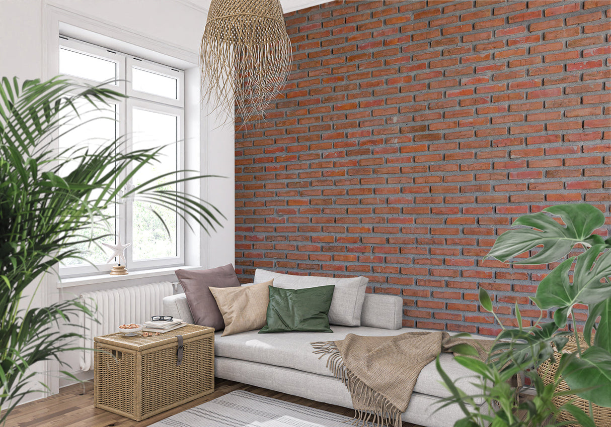 Red brick wall mural in modern living room with grey sofa and industrial lighting